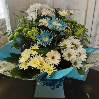 See Breeze - A stunning handtied in water presented in a gift box/bag. Created using white and blue flowers with complimentary foliage. Hand delivered with care by the Flower Studio Rochdale.