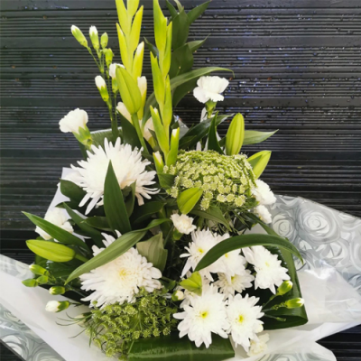 Purely Beautiful - A beautiful in water presented in a gift box/bag. Created using all white flowers with complimentary foliage. Hand delivered with care by the Flower Studio Rochdale.